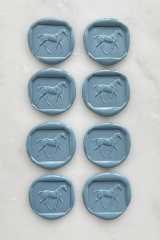 Photo of a set of 8 French blue wax seals featuring a walking horse design by Danielle Demers.