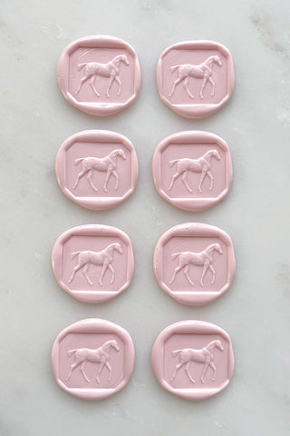 Photo of a set of 8 petal pink wax seals featuring a walking horse design by Danielle Demers.
