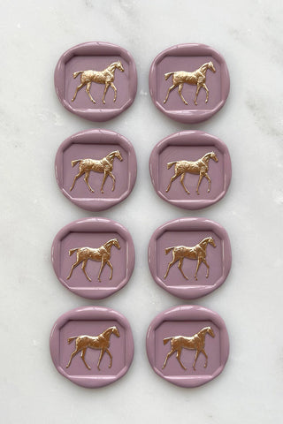 Photo of a set of 8 dusty rose horse wax seals with gold hand painted detail by equine artist Danielle Demers