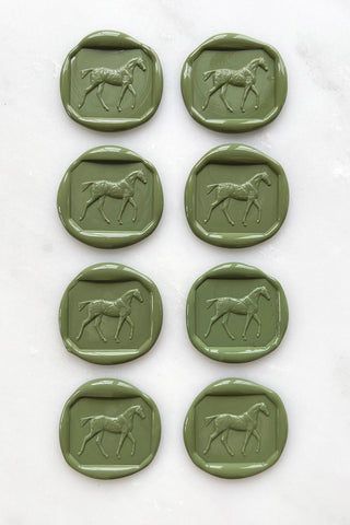 Photo of a set of 8 sap green wax seals featuring a walking horse design by Danielle Demers.
