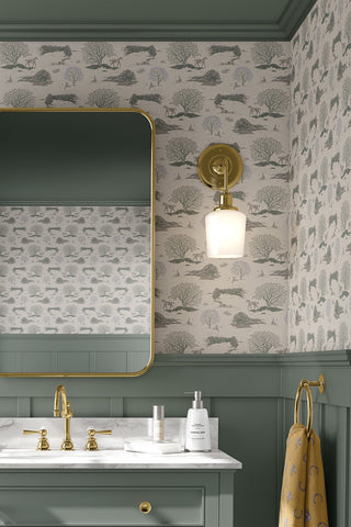 Interior bathroom scene featuring Countryside Toile wallpaper in the colorway "Warm Grey." Designed by equine artist Danielle Demers.